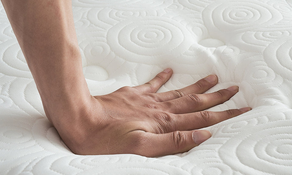 Close-up of the mattress surface showing intricate quilted pattern with circular and swirl designs.